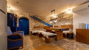 A rustic stone-walled room with a wooden bench, a blue door, and a staircase. - Villa O'Lucky with pool and unique tavern "konoba" (Polje (Krk))