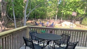 A wooden deck with a round table and six chairs. - Highland Comfort - Private Peaceful Retreat (Chapel Hill)