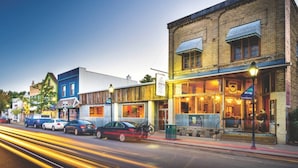 A street view with a building that has a sign for a restaurant and a bar.