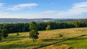 A rural landscape with rolling hills, a clear sky, and a few scattered trees. - Stunning Views, Sleeps 20, Pool, Hot Tub, 7 bedrooms (York)