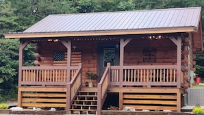 A wooden cabin with a porch, steps, and a door. - Bennett Lake Tiny Cabin  (Whitwell)