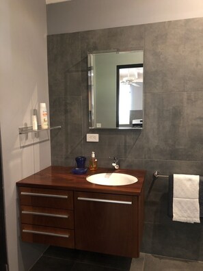 Een douche, handdoeken, zeep, toiletpapier