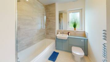 Bathtub, hair dryer, towels, soap