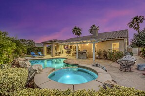 A backyard with a swimming pool, lounge chairs, and a covered patio area. - Feel yourself at home !!! (Indio)
