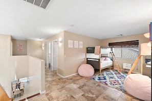 A modern bedroom with a bunk bed, a desk, and a small seating area. - Desert Oasis Amazing Pool/Waterfall/Firepit/Office (Casa Grande)