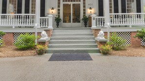 A two-story building with a white exterior, a front door, and a balcony. - Liberty Hall Bed and Breakfast (Pendleton)