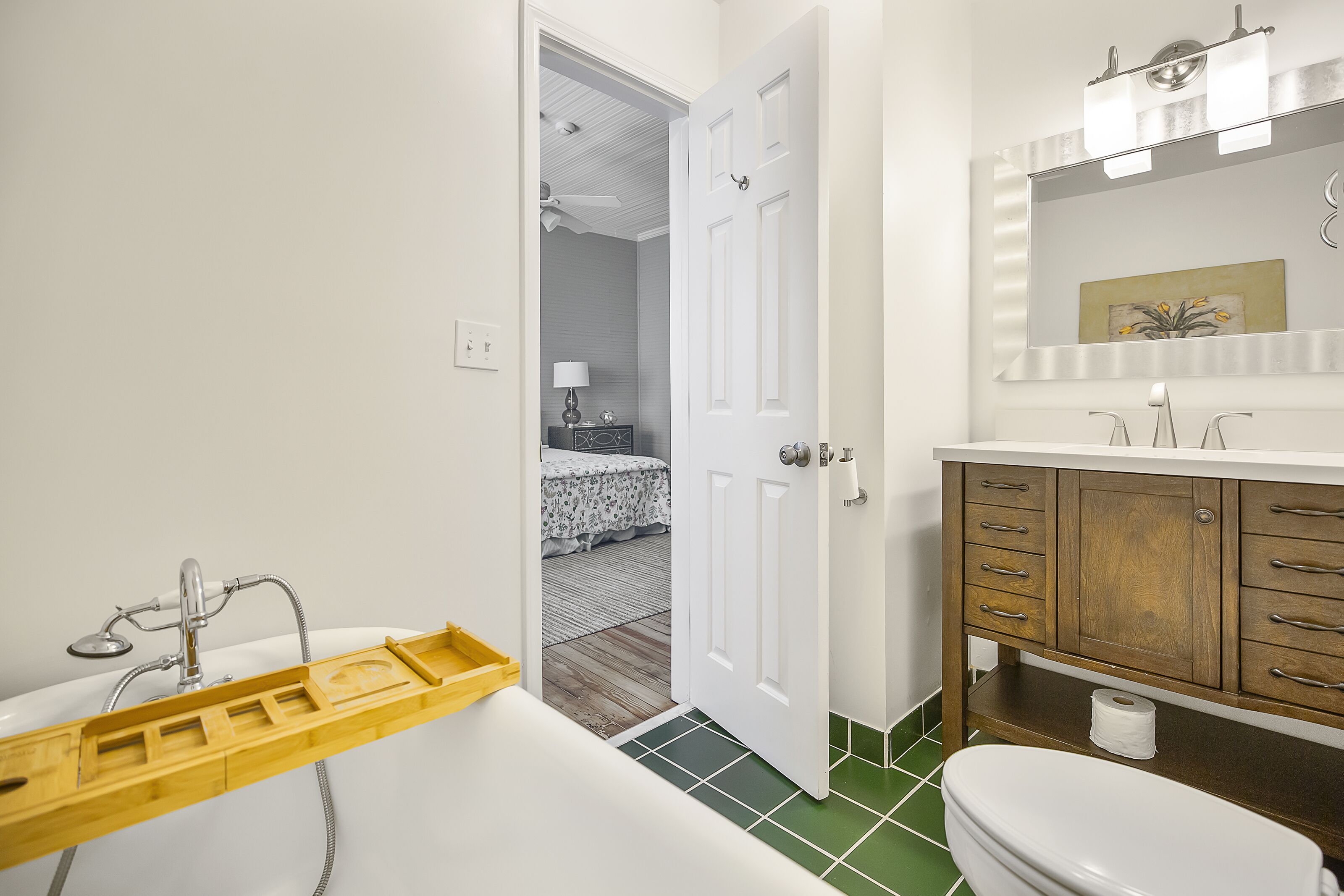 A bathroom with a bathtub, toilet, and vanity.