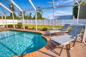 A pool with a clear blue water surface, surrounded by a white fence, and equipped with lounge chairs. - Gulfstream Villa | Heated Pool + Dog Friendly (Englewood)