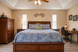 A bedroom with a bed, dresser, desk, chair, and ceiling fan. - Gulfstream Villa | Heated Pool + Dog Friendly (Englewood)