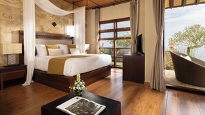 Un dormitorio con una cama grande, suelo de madera, televisión y un balcón con vistas.
