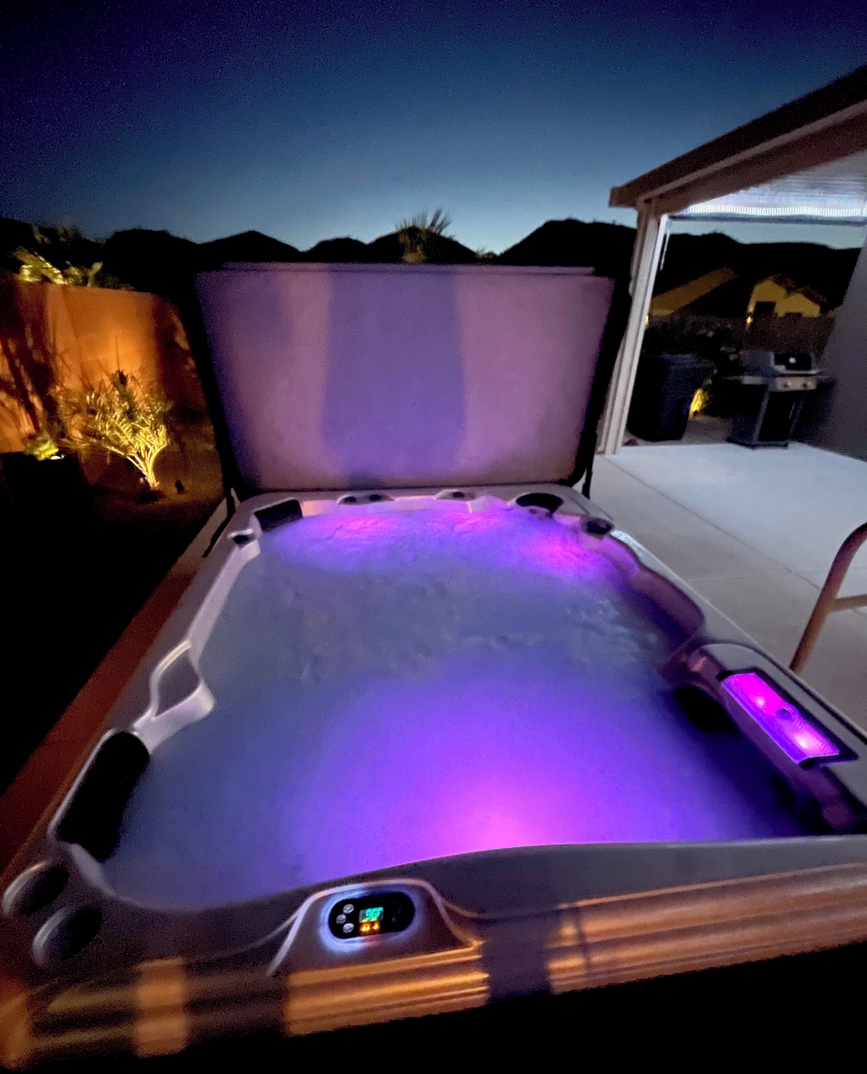 A hot tub with a digital control panel and LED lighting.