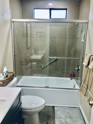 Combined shower/tub, hair dryer, towels, soap