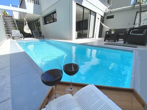 Relax by the pool with a refreshing drink and a good book.