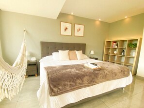 Relax in this serene retreat with a large bed, hammock, and bookshelf.