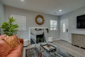 Relax in a cozy seating area with a sofa, coffee table, and fireplace.
