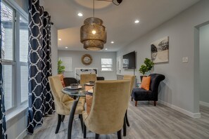Enjoy meals in this stylish dining area with a round table and comfortable seating for four.