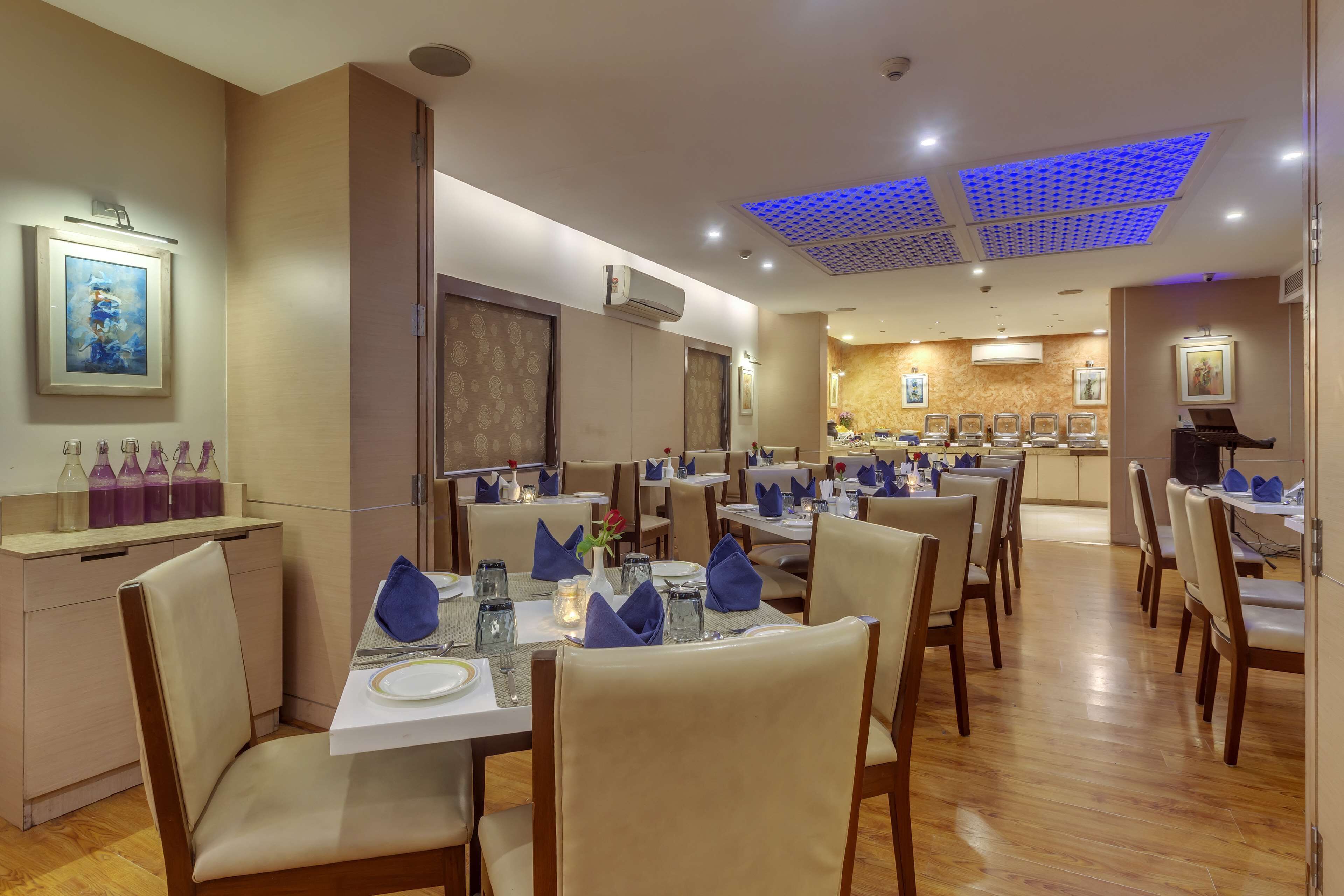 A restaurant with multiple tables, chairs, and a piano.