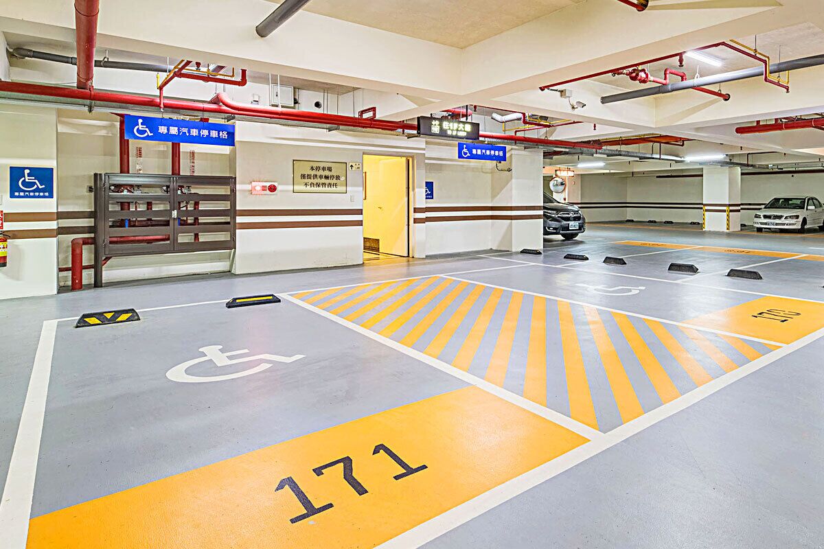 A parking garage with handicapped accessible spaces, marked with a wheelchair symbol and the number 171.