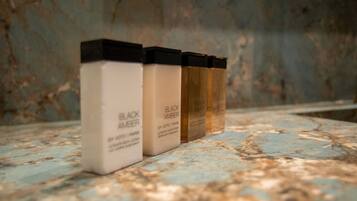 Three skincare products on a marble surface.
