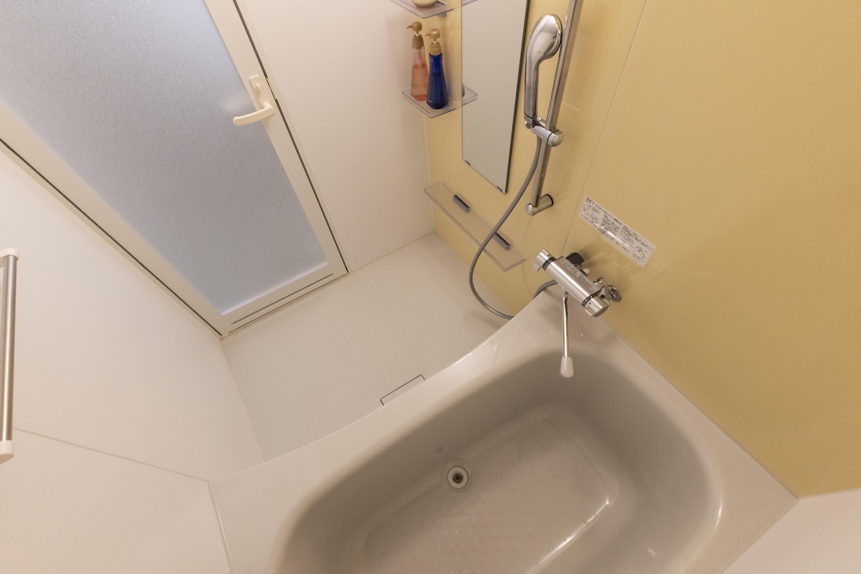 A bathroom with a bathtub, a shower, and a toilet.