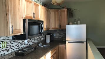 Fridge, microwave, coffee/tea maker, cookware/dishes/utensils