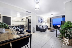 Relax in a spacious living area with a sofa and flat-screen TV, or enjoy a meal at the dining table.