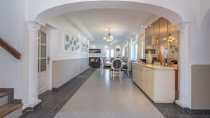 A hallway with a dining area, kitchen, and staircase. - Villa 'Del Sol - Entre Tu y Yo' with Sea View, Heated Pool, 3 Terraces & Wi-Fi (Benalmádena)