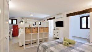 A bedroom with a bed, a wardrobe, a television, and a window. - Holiday Home "Loft Pina" with Wi-Fi, Garden & Terrace (Arbatax)