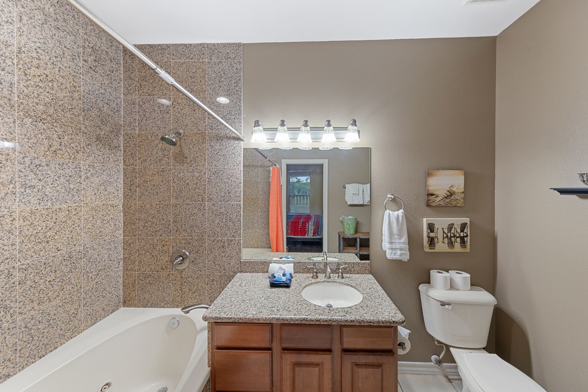 A bathroom with a bathtub, a sink, and a toilet.