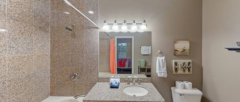 A bathroom with a bathtub, a sink, and a toilet.
