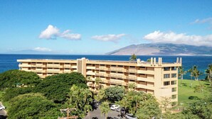 A multi-story hotel with balconies overlooking a coastal area.