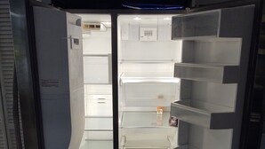 A modern, empty refrigerator with multiple shelves and drawers, indicating ample storage space. - Great location.  Ten minutes from  Beach.  Peaceful retreat! (Merritt Island)
