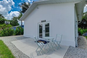 A white building with a sign reading "Hotel". - Charming Downtown Retreat with Courtyard (Bonita Springs)
