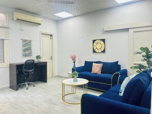 32-inch LED TV with cable channels - BluO 1BHK - DLF Galleria | Balcony, Suite (Gurugram)