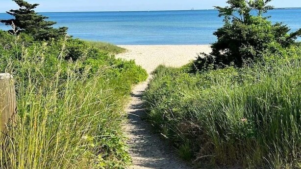 A pathway leading to a beach with a clear view of the ocean. - The Breakwaters Hyannis - Your Home Away From Home! RPAM046 (Hyannis)