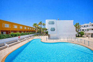 Une piscine avec, en arrière-plan, un bâtiment à l’architecture moderne.