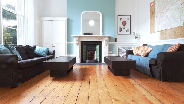 A living room with a fireplace, two sofas, and a coffee table.