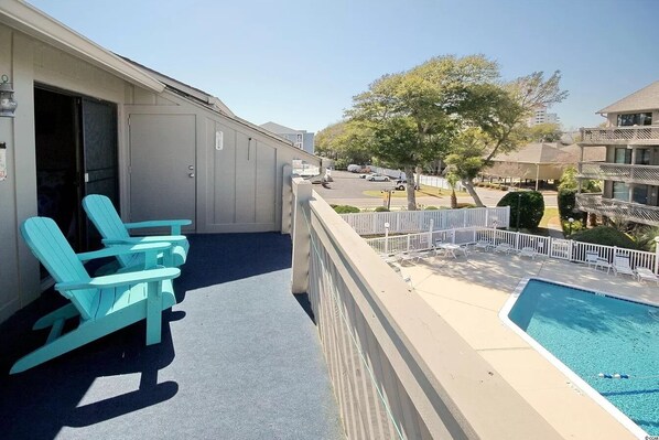 Relax by the pool with a clear view of the surrounding neighborhood from this hotel's balcony.