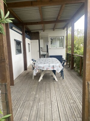 Enjoy al fresco dining at this charming outdoor space, featuring a round table and comfortable seating for four.