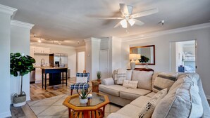 A modern living room with a sofa, coffee table, and a ceiling fan. - Family Oasis 1 block from the beach near Boardwalk (Carolina Beach)