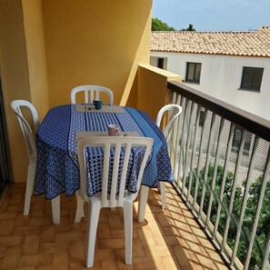 Enjoy a romantic meal for two on this balcony with a table set amidst a charming view.