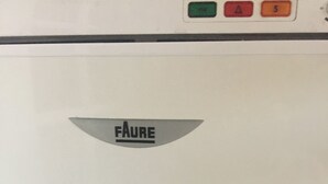 A white wall with a grey logo of "FAURE" and three red buttons above it. - Logement Clair ET Spacieux (Paris)