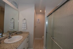 A bathroom with a sink, mirror, towel rack, shower, and toilet. - Canal View 2BR Retreat, Near Bonita Beach! Sleeps 4 (Bonita Springs)
