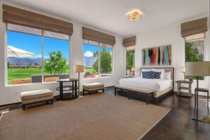 Relax in a spacious room with a large bed, two bedside tables, and a comfortable seating area.