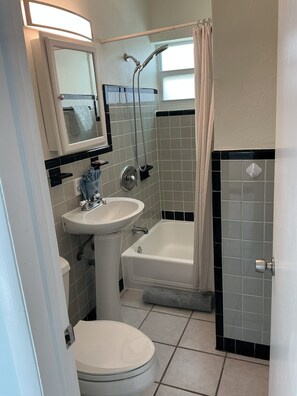A bathroom with a toilet, sink, and bathtub. - Private Pool & Dock (Marathon)
