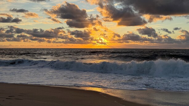 A beach with waves and a sunset. - Charming Waterfront Retreat with pool & short stroll to beach! (Ocean City)