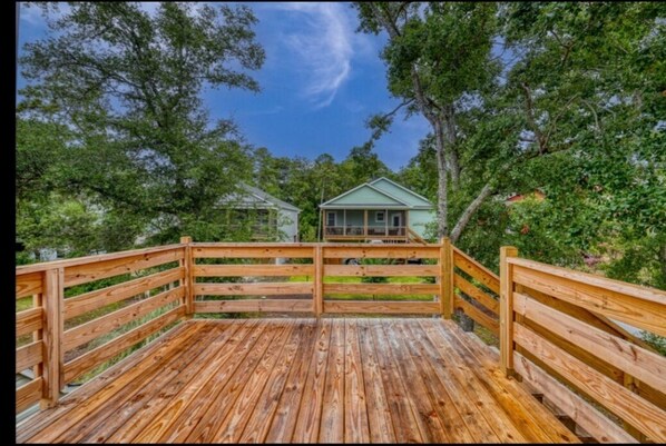 Escape to a serene retreat surrounded by lush greenery and trees, with a porch and tranquil atmosphere.