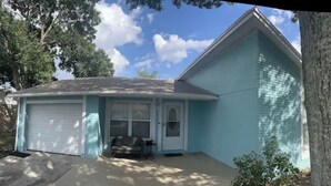 A single-story house with a garage, a front porch, and a small patio area. - Tampa home (Tampa)