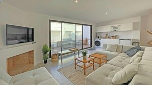 A modern living room with a sofa, a coffee table, and a fireplace. - Casa del Pescadores - Four Bedroom House, Sleeps 8 (L'Escala)