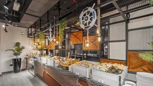 A buffet setup with seafood, wooden accents, and hanging plants. - Wyndham Residences The Palm (Dubai)